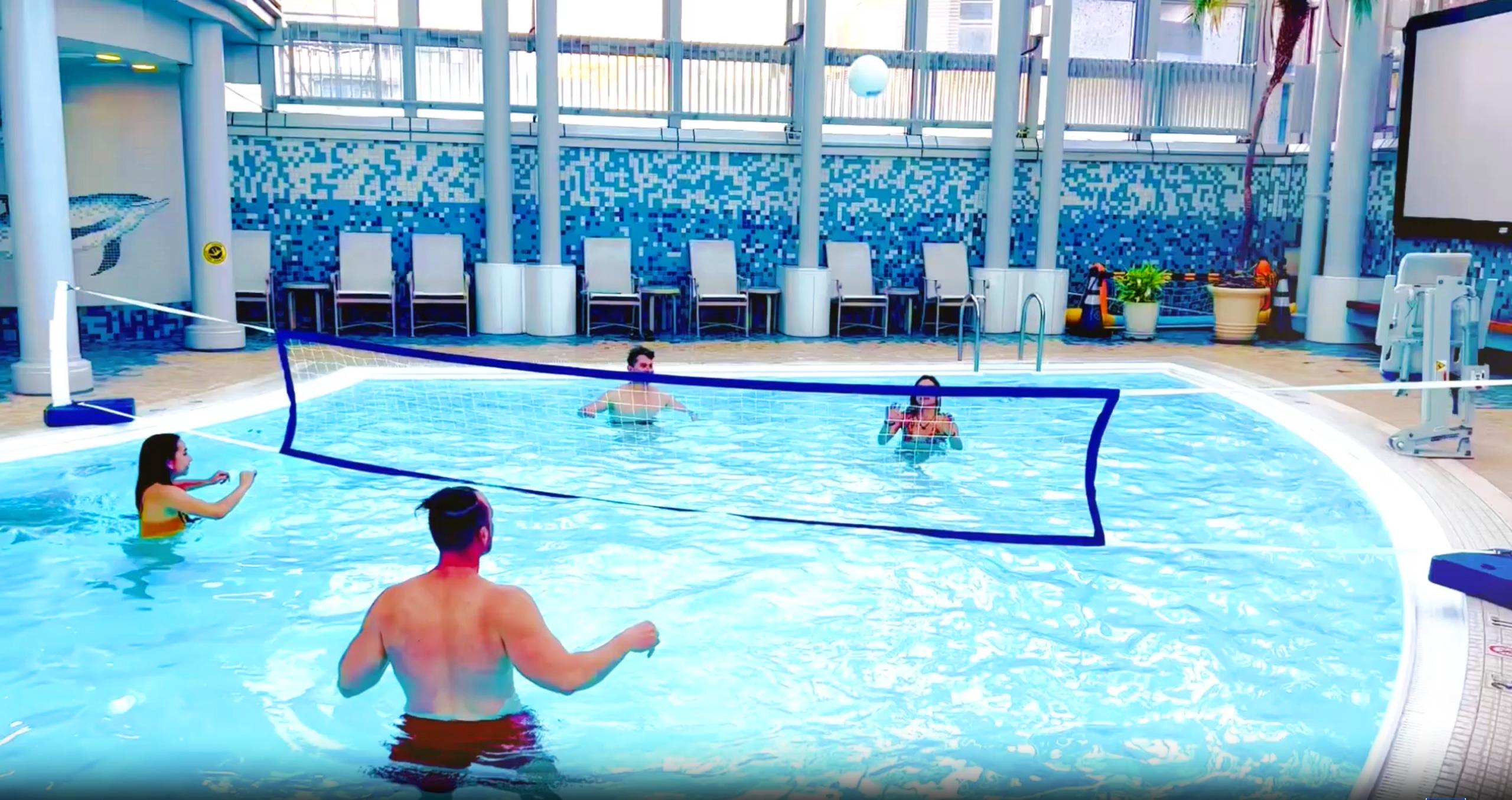 Image of People playing water volleyball in the pool